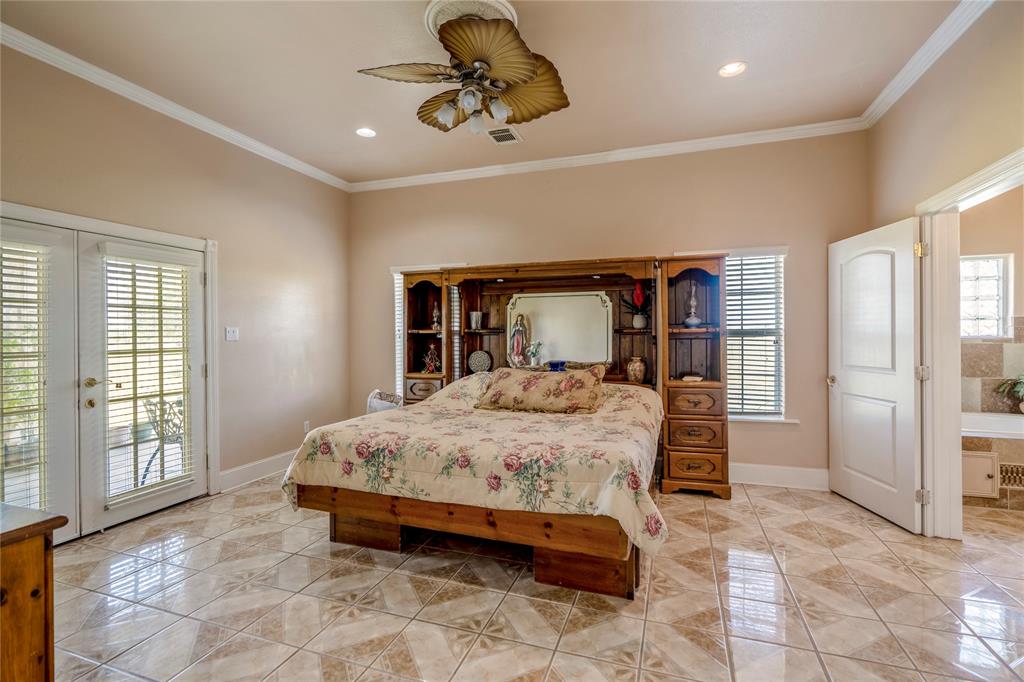 2nd Primary bedroom Downstairs with French doors leading to the covered patio