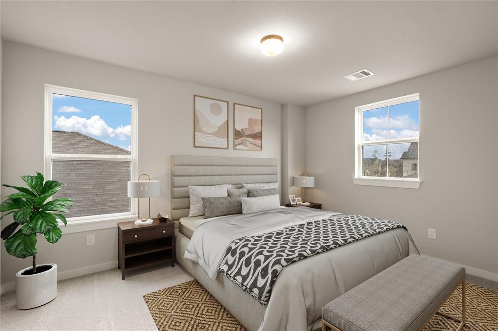 Secondary bedroom features plush carpet, custom paint and large windows.