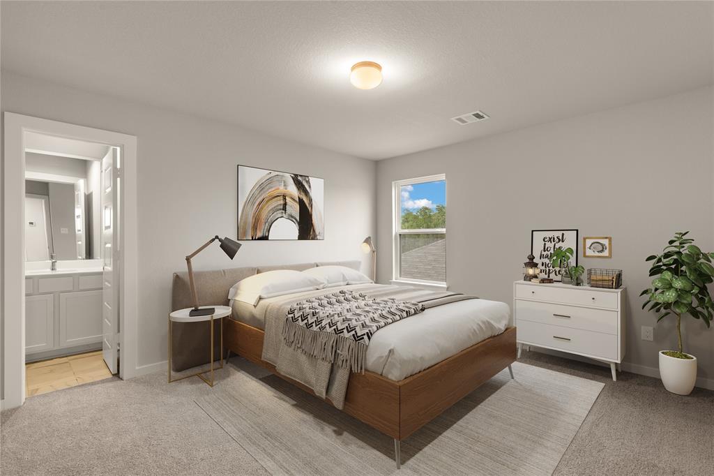 Secondary bedroom features plush carpet, custom paint, a large window and access to a private bath.