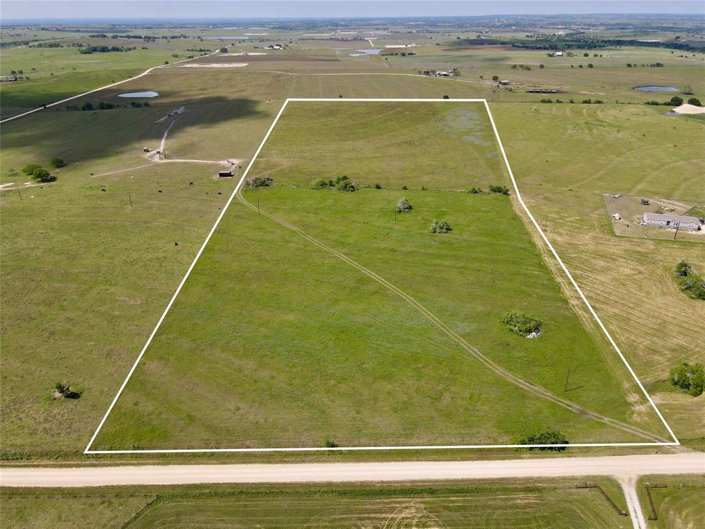 22 acres of rolling terrain, hilltop views, improved pasture, and wide open spaces, you must come see it to appreciate the views! Build your dream home and have views for miles and miles. You can see both the city of Moulton and the city of Shiner from this 450ft elevation! This property is located halfway between Moulton and Shiner and is convenient to Houston, Austin, or San Antonio. You are minutes from the world famous Spoetzl Brewery! The improved pasture is the perfect habitat for cattle and horses. Ag valuation with hay production. Fencing on the North, South, and West side. 

Perfect for building a grand entrance to your hilltop dream home! Rural real estate in this acreage size is a golden opportunity.