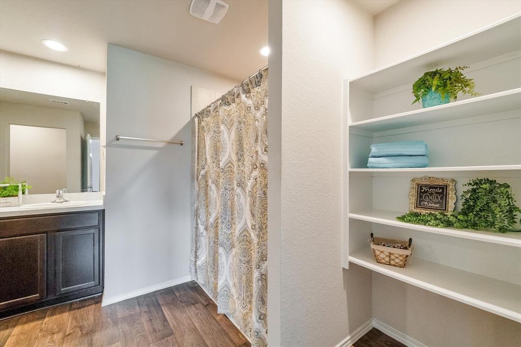Built-in shelving located in primary bathroom.