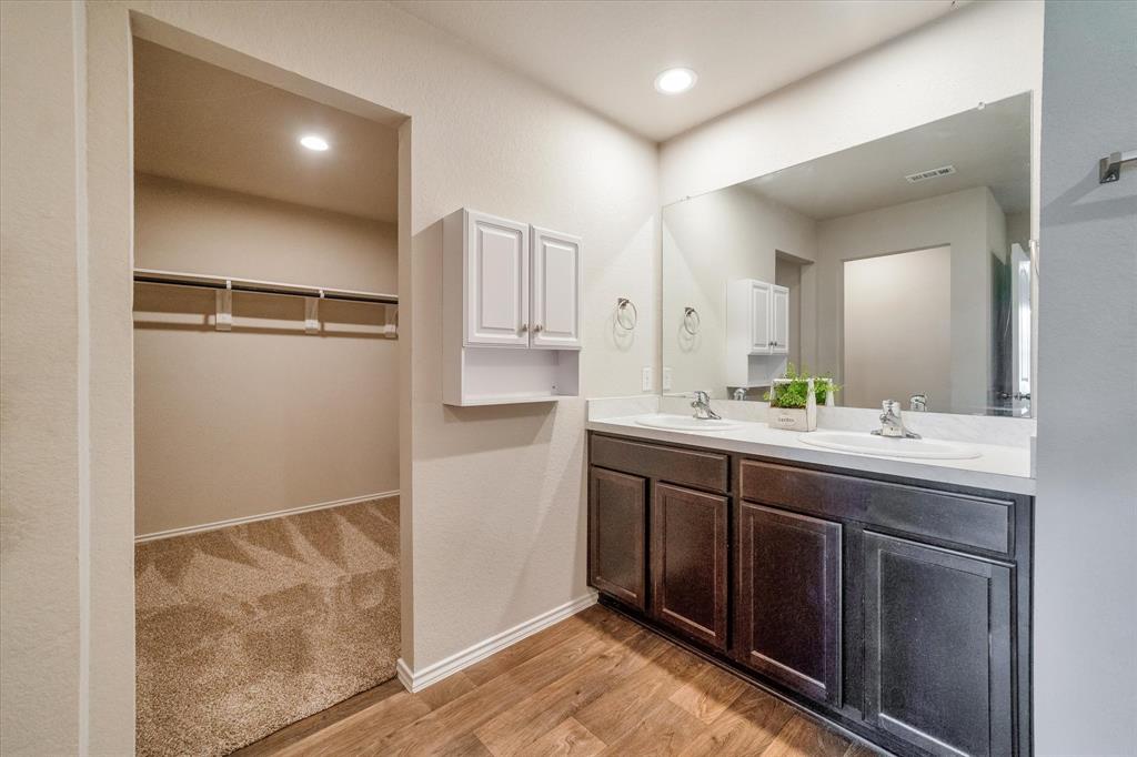 Primary spacious walk-in closet open to bathroom