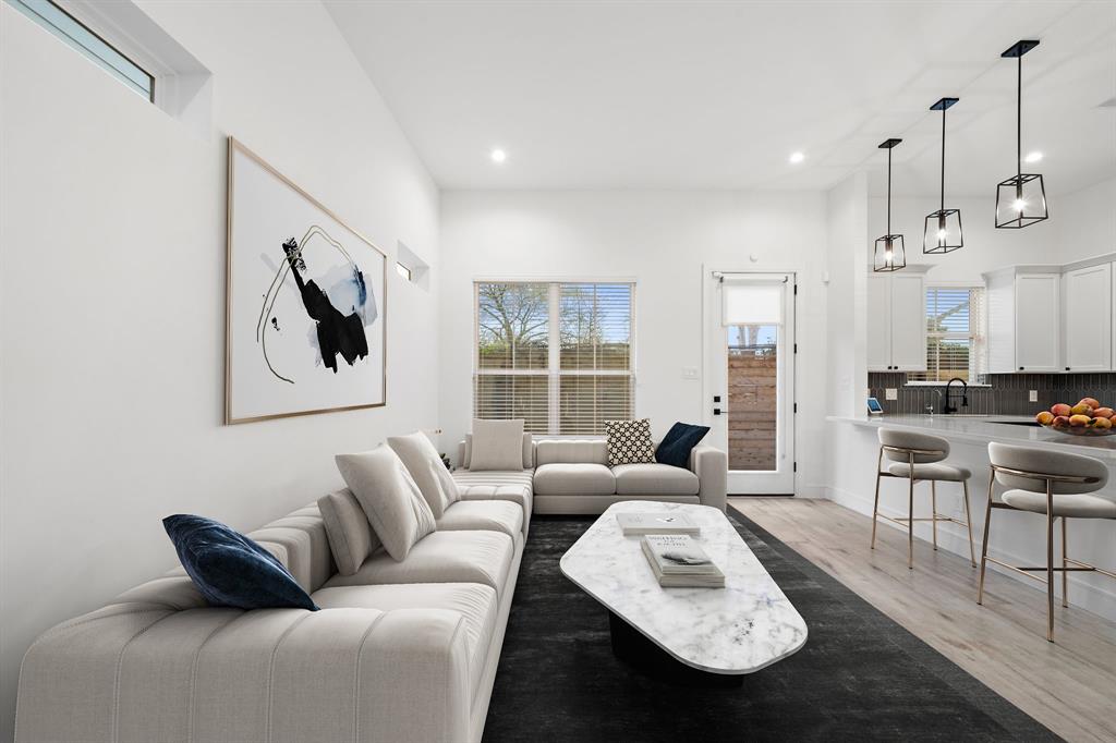 The living area offers abundant natural light streaming in from the wide windows and the full-lite door that opens to the fully-fenced backyard.