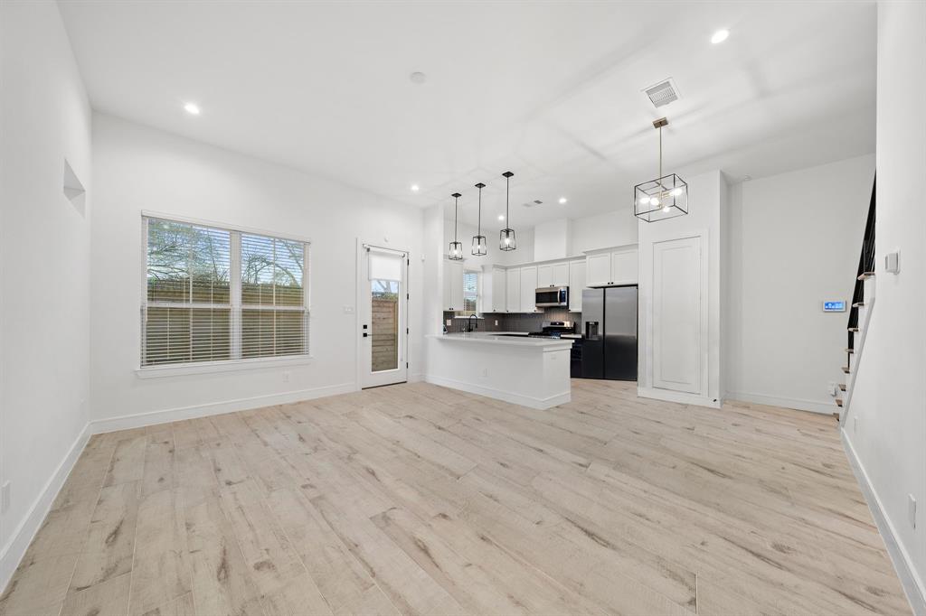 Easily extend your entertainment space to the outdoors with a great indoor-outdoor flow between the open-concept kitchen/living area and the backyard.