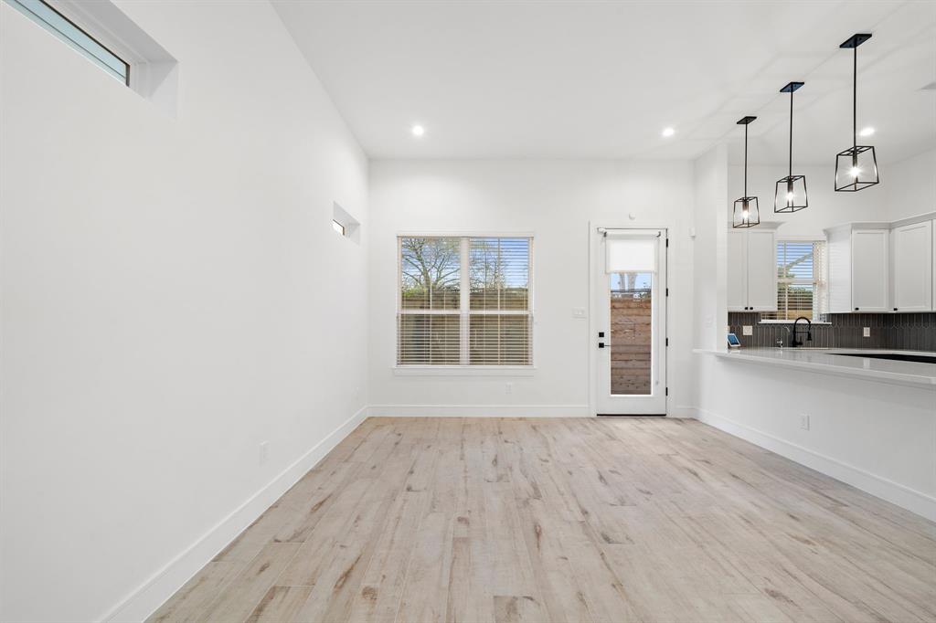 The living area is adorned with engineered wood flooring and sleek baseboards that add character to the space.