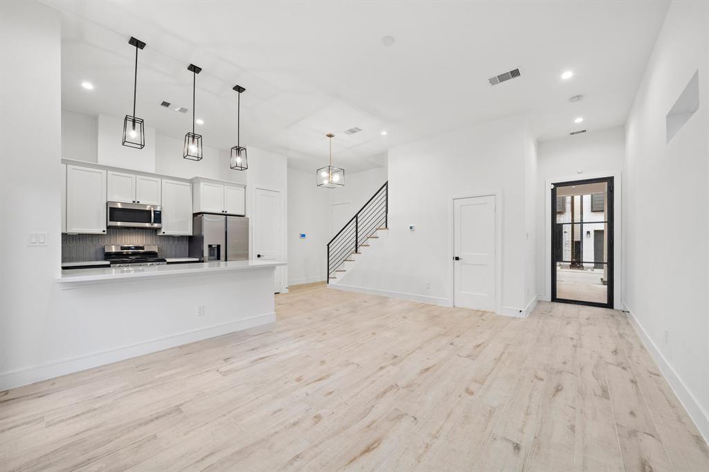 Effortlessly lead guests into the living area located right off the entry. The powder room is conveniently located for guests to use.