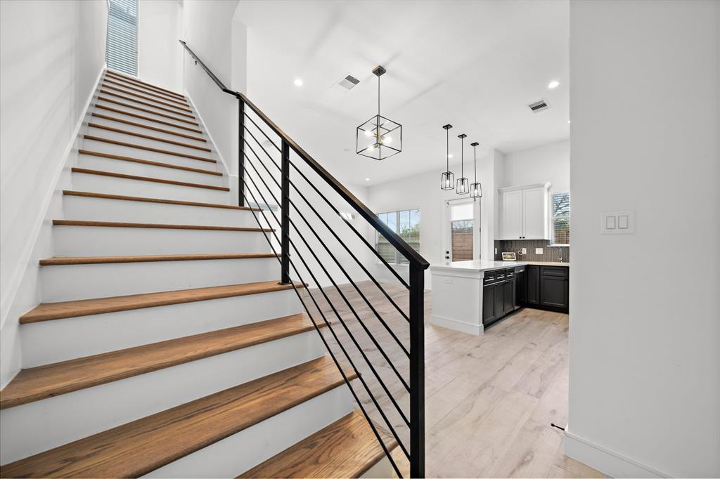 Enjoy an easy transition from the first floor to the upstairs bedrooms through the staircase with sleek iron railings and engineered wood landings.