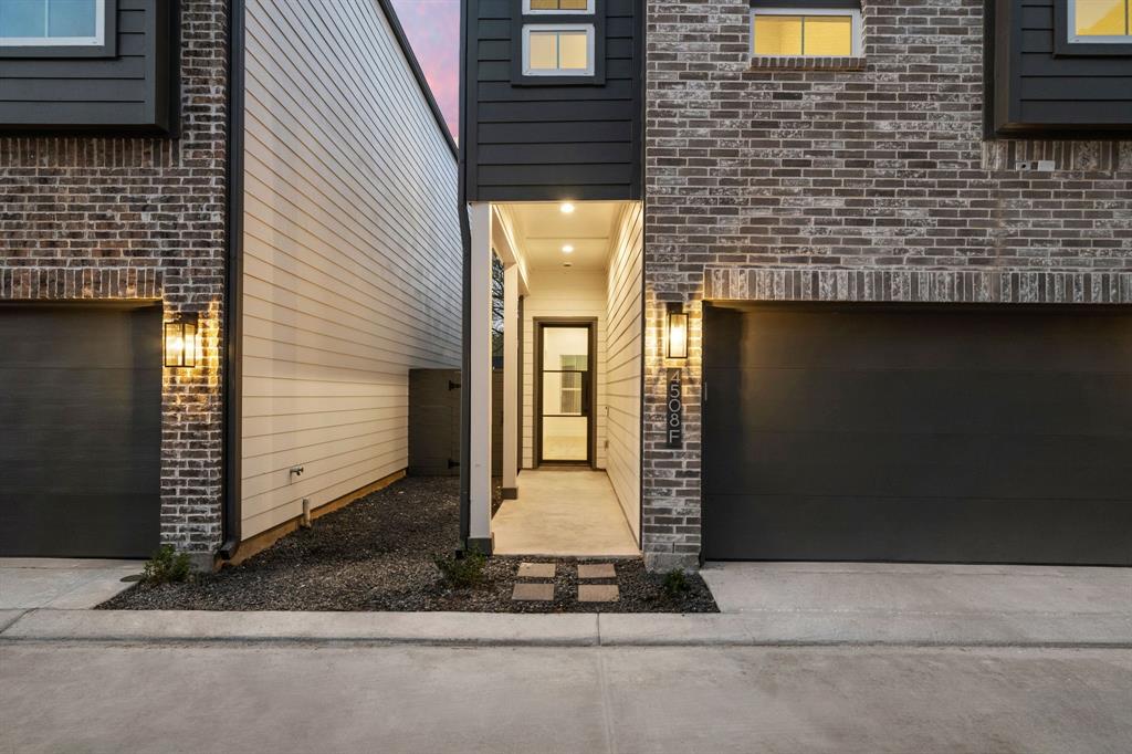 A beautiful combination of brick and wood siding provides a classic yet modern exterior, with recessed lights illuminating the front entry for a warm and welcoming ambiance. Wide parking options are available inside the attached 2-car garage.