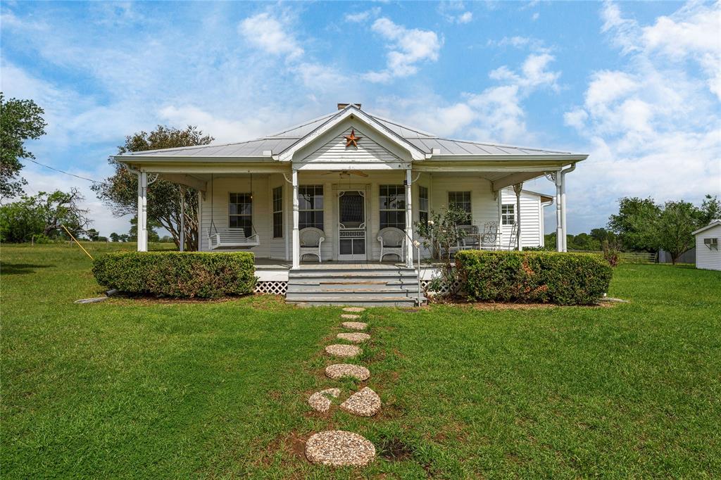 Beautiful Bastrop County legacy ranch awaiting new owners to continue the heritage. This 32 acre ranch has been in the same family since the early 1900’s! Built in 1918, this farmhouse has undergone quite a transformation and has the bones of a modern new build. Look out from your kitchen windows over the stock tank in the back and enjoy your morning coffee on the front porch rocking chair. 
The ranch has improved grasses ready for grazing. A water well feeds the pond and has also been plumbed to a fenced off 3 acre orchard that never came to fruition. However the 28 drip locations are still in place and could be put back into service. The house is serviced by Aqua water and an owned propane tank services the hot water heater and the fireplace.