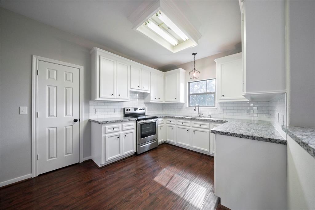 Chic kitchen with new appliances, subway tile backsplash, upgraded counters.