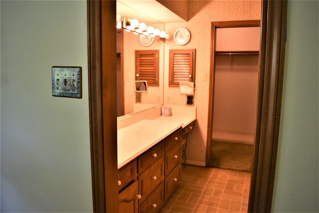 Primary bath has a sink and built in vanity with large walk in closet