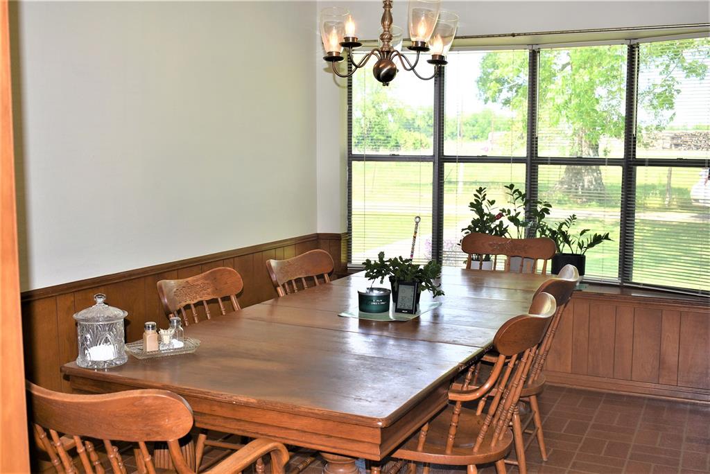 Bright and cheerful dining room with its BAY window overlooking the front yard. what a place to gather and this is a huge dining table BTW. Could easily put service for 8 at this one. Table does not convey however but you get the idea!