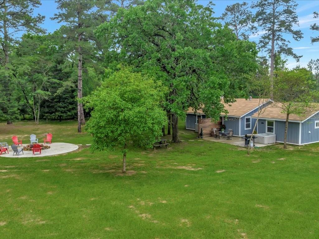515 Running Deer Road Grapeland, Texas Welcome to this fully renovated, turn key property in a quiet neighborhood near Houston County Lake! The home is a three bedroom, two and a half bath with an additional bonus room/office. The property is 4+ acres of beautiful meadow, soaring pines and roaming deer. There is also has huge fire pit area and a patio with hot tub for entertaining. Enjoy privacy, peace and quiet! At night, the stargazing is breathtaking! If a small, hobby farm is your dream, horses are allowed on this property and it is fully fenced.
