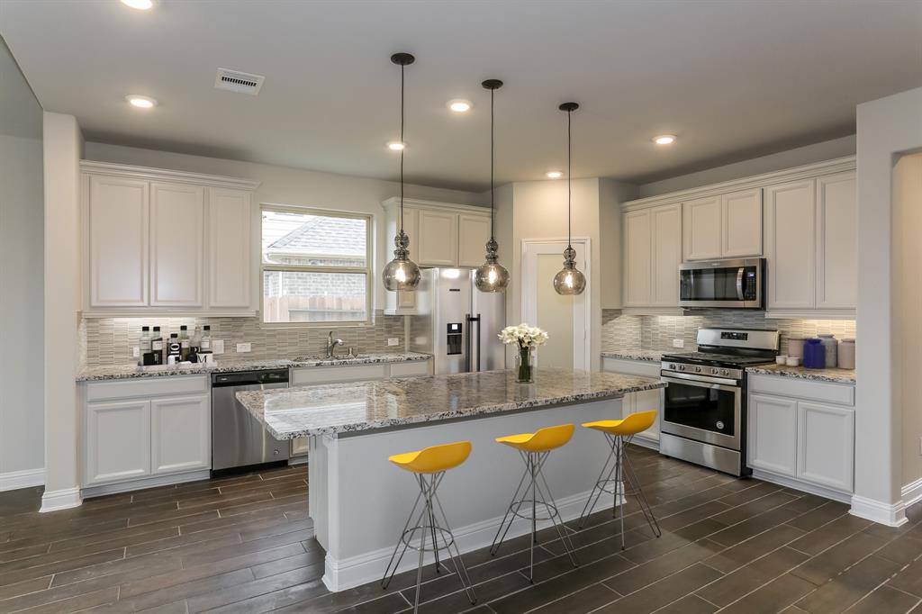 **Home is Under Construction. The photo shown here is of a completed home that has the same floor plan and similar elevation. Options and color selections may vary.**