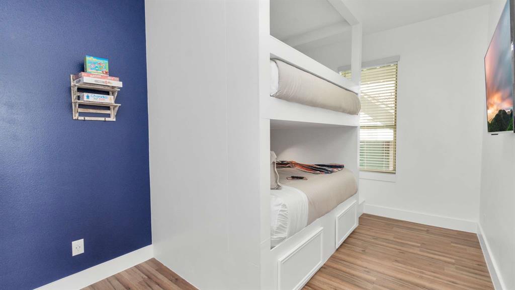The secondary bedroom includes queen over queen bunk beds.
