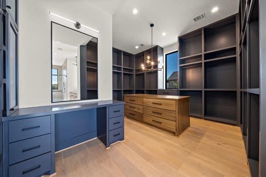 The primary closet has extensive custom millwork and built-ins.