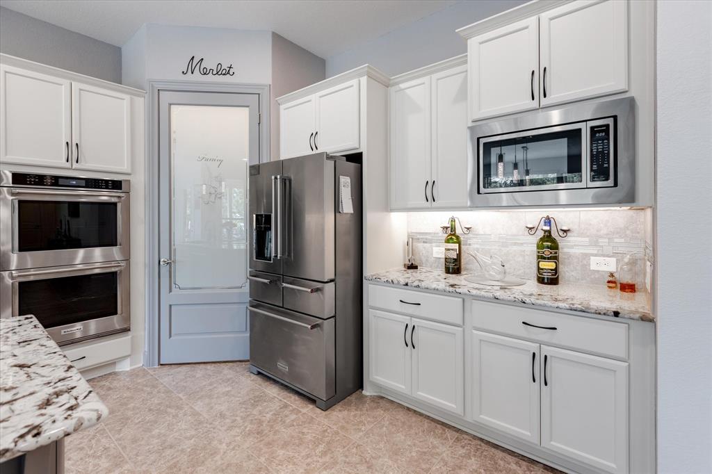 The Custom pantry door brings more fun to this kitchen.