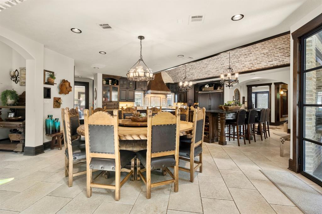 Entering the kitchen this "breakfast table" is large enough for 12 and the bar can accommodate 4 or more. Kitchen has 2 sets of French doors which lead out into the back patio area.