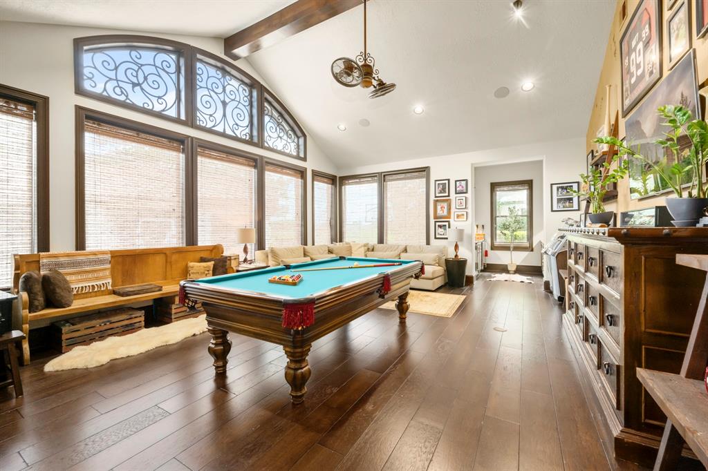Find yourself ENTERTAINED in this incrediable downstairs game room anchored with a full wet bar and separate craft room with built in desks and cabinetry. All window coverings are custom Hunter Douglas and can be opened "Bottom-up" or "Top-Down" to maintain privacy.