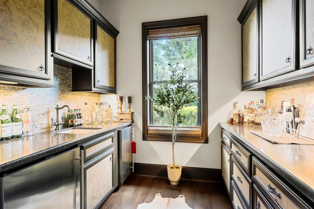 Wet bar located off of game room. Entertain in style and mix drinks without missing your favorite movie or shot at pool.