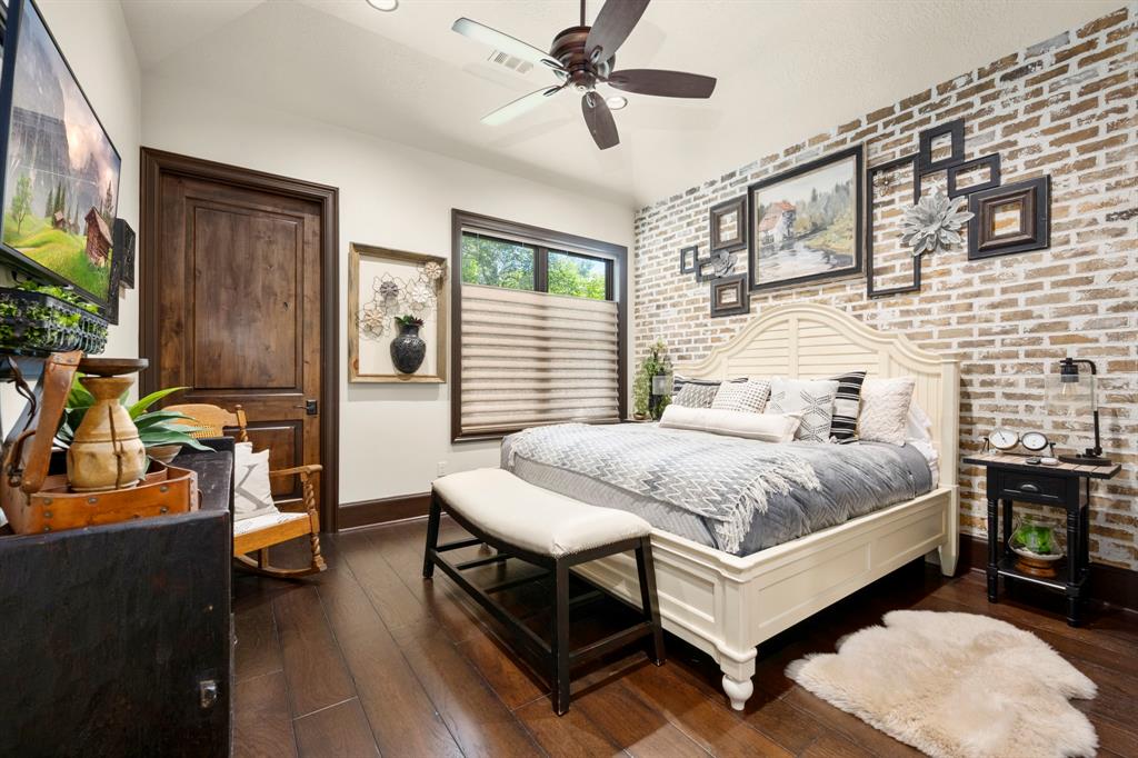 Downstairs suite is perfect for guests. Accented brick wall, ensuite bath and walk-in closet.