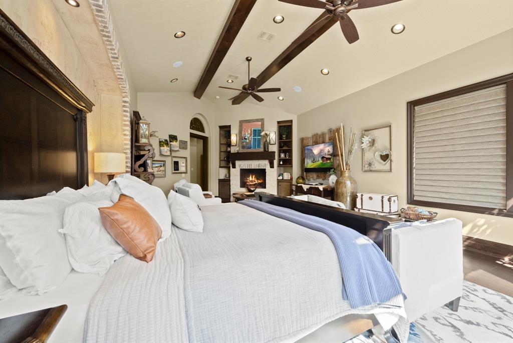 Vaulted ceilings give the primary suite extra depth and the custom alcove has separate lighting areas for either side of the bed.
