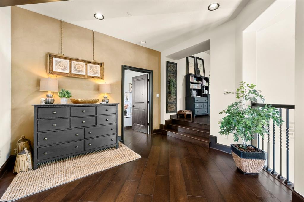Once upstairs you are greeted with multiple closets for storage and a secondary laundry room complete with chute! (to the first floor laundry room) Here is the elevated entrance to the southern wing of the upstairs which has 2 beds, game room with work nook, media room and wet bar.