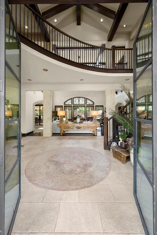 French bullicante-styled doors lead into a 2 story foyer that not only has style but charm.