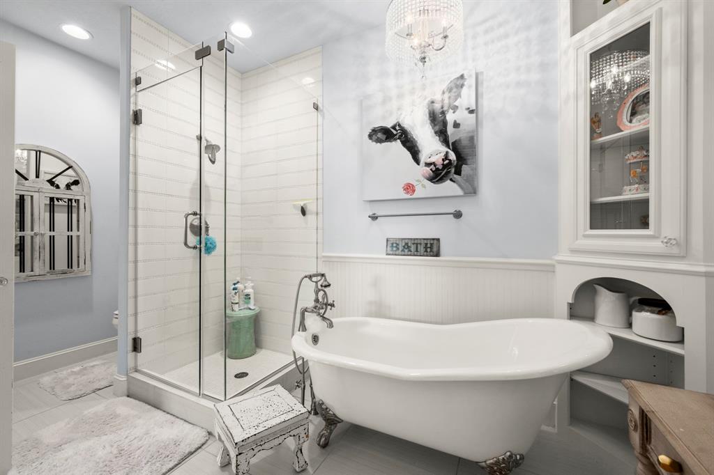 Bath has separate custom vanity with glass inlaid cabinets and great designer colors.