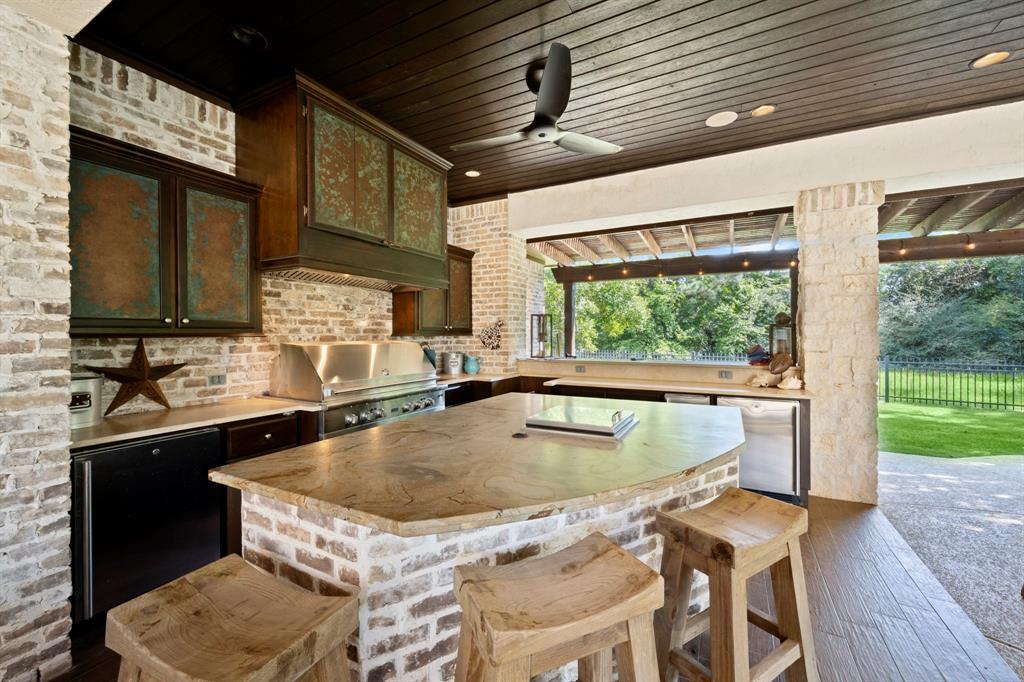 Full viking outdoor kitchen with 6 burner stove, separate burner (perfect for crawfish), ice maker, fridge and cooler located in the middle of the island.