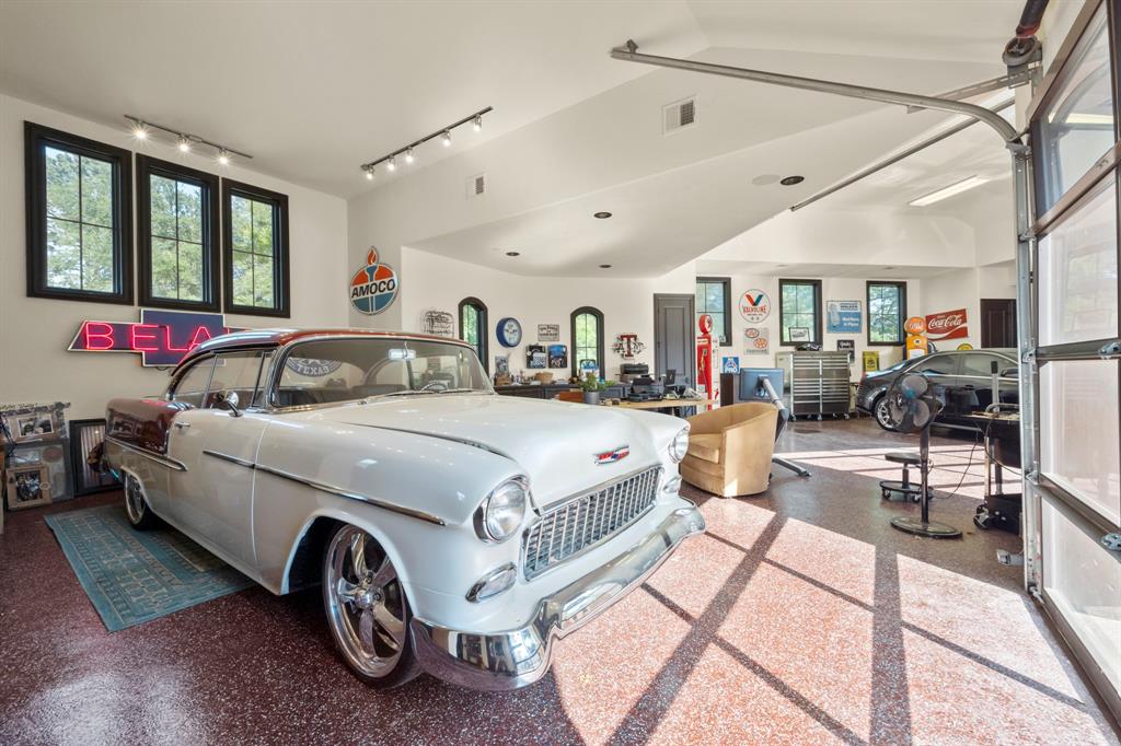 The garage will accommodate 5 vehicles but as many as 8 if lift is installed. Garage height and door are prepared to accommodate lift. Epoxy floor with separate AC and bathroom. Office space included with tons of storage and dedicated GOLF CART parking.