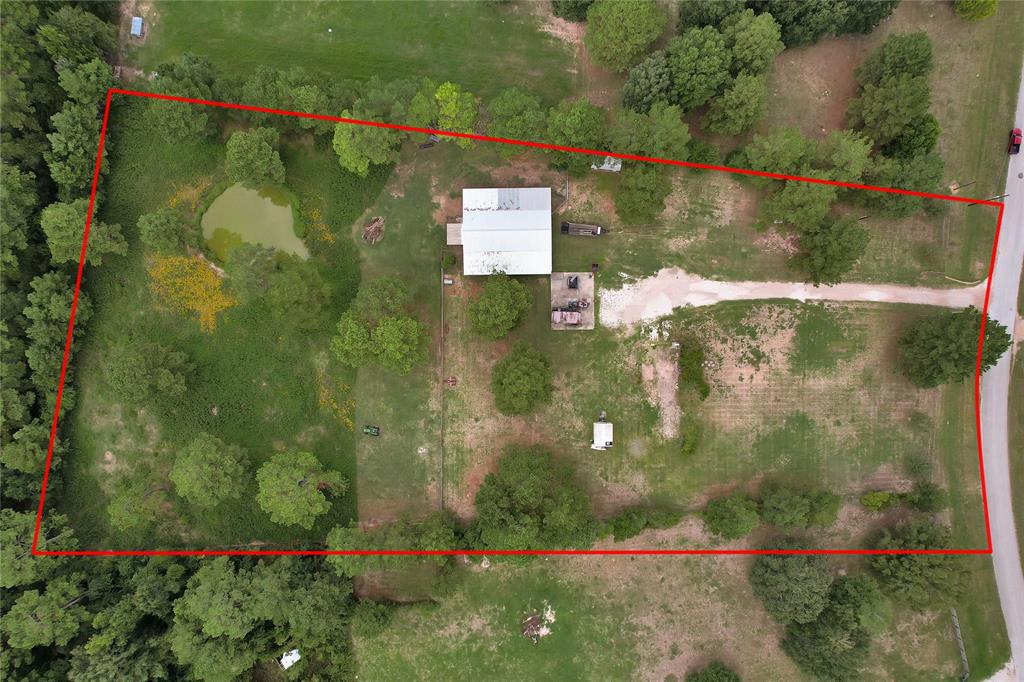 This is one you've been holding out for!
 ** UNRESTRICTIED** 
4.89 Acres in Splendora ISD.

This gem is located in a prestigious neighborhood. This beauty is completely cleared and completely fenced.
It's ready for you to build your custom home on, working septic and well is already in place along with a 30 x 40 concrete slab  a great start of what can be your home or shop.
Bring your livestock, it already has a 60 x 66 barn with 18 x 60 concreted area.
The back portion of the property is crossed fenced and has a pond.