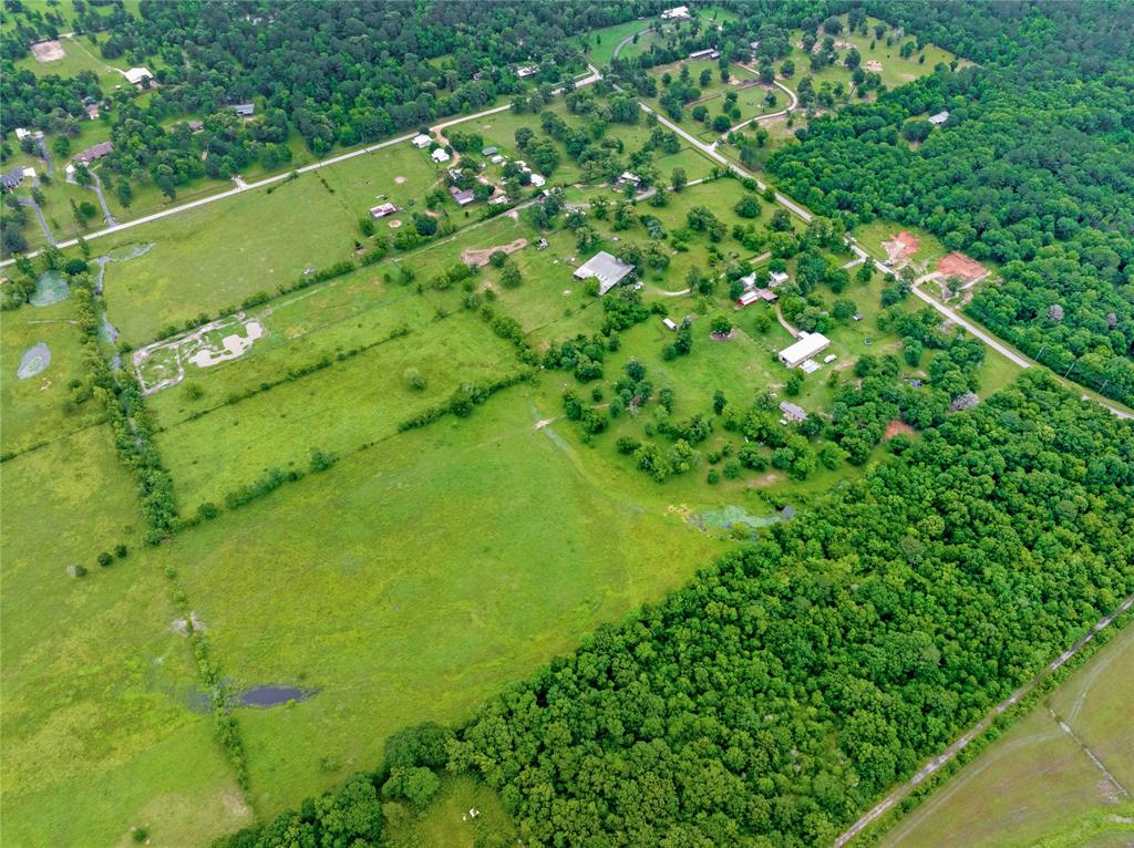 Rare opportunity on 23.435 rolling acres in Magnolia. Start your own business with a 120X40 machine shop, separate building for office use & 4 big classrooms. An amazing party barn also sets this property apart from no other. The land is fenced/cross fenced & has 2 ponds for livestock. And believe it or not, there is an inground pool for an afternoon refreshing swim on a hot summer day. 3 separate septic systems. 3 phase power. Previous rental history of $5k per month for 5 years.