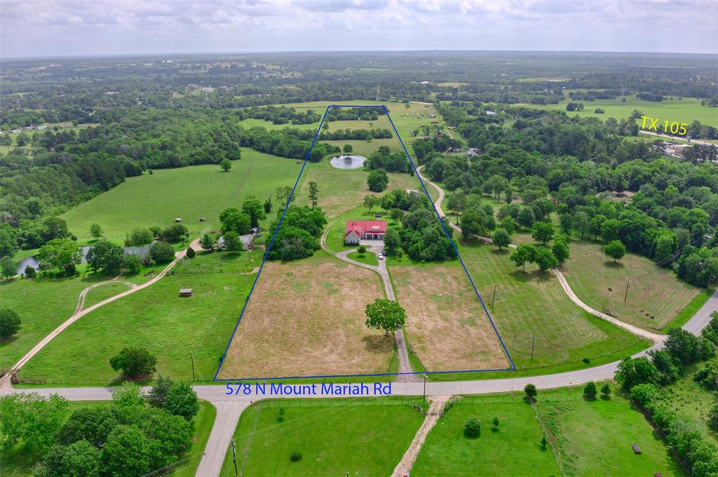 Welcome to your Texas dream: 23 rolling acres fenced & cross fenced with improved pastures, pole barn, porches, pool and a beautiful pond. Custom 3/4 bedroom, 3.5 bath home with study boasts spacious open floor plan with architectural details thru out. All bedrooms, study & living space downstairs plus bonus area upstairs as game room or 4th bedroom, storage & full bathroom. Cathedral ceiling in living room is accented with wood beam & 2 story stacked stone fireplace. Living room features wall of double doors that open onto the Texas sized back porch with outdoor kitchen & view of the sparkling pool. Home is perched on top of the hill for a sweeping view of the land and Texas sunrise. Clusters of hardwood trees & native Texas trees separate the pastures and adjoining tracts. Ag exemption in place for hay & pastures. Pole barn for equipment. 3 car garage. Upgraded metal roof. Private water well. Automatic gate system enters onto crushed rock driveway. Highly acclaimed Montgomery ISD.