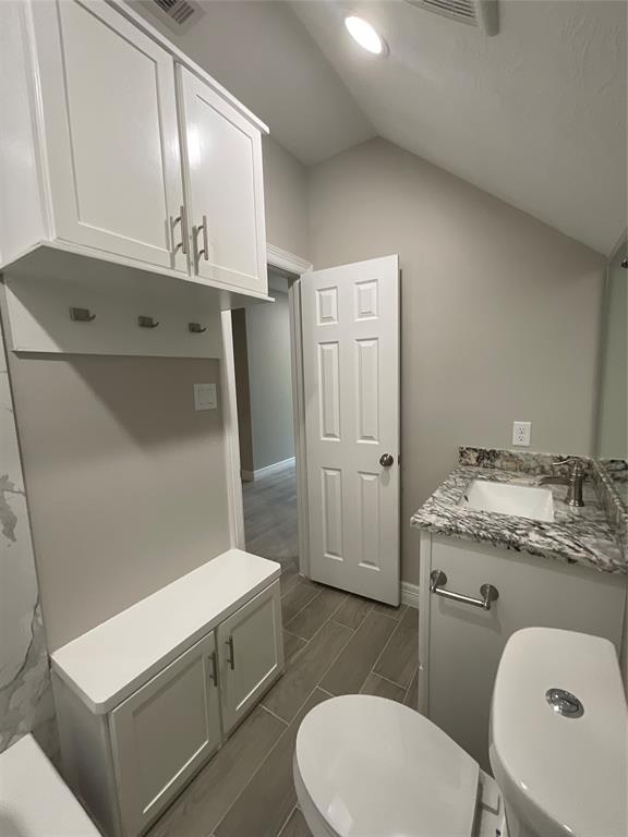 View of Upstairs Bathroom with Granite Countertop Vanity and Custom Cabinets.