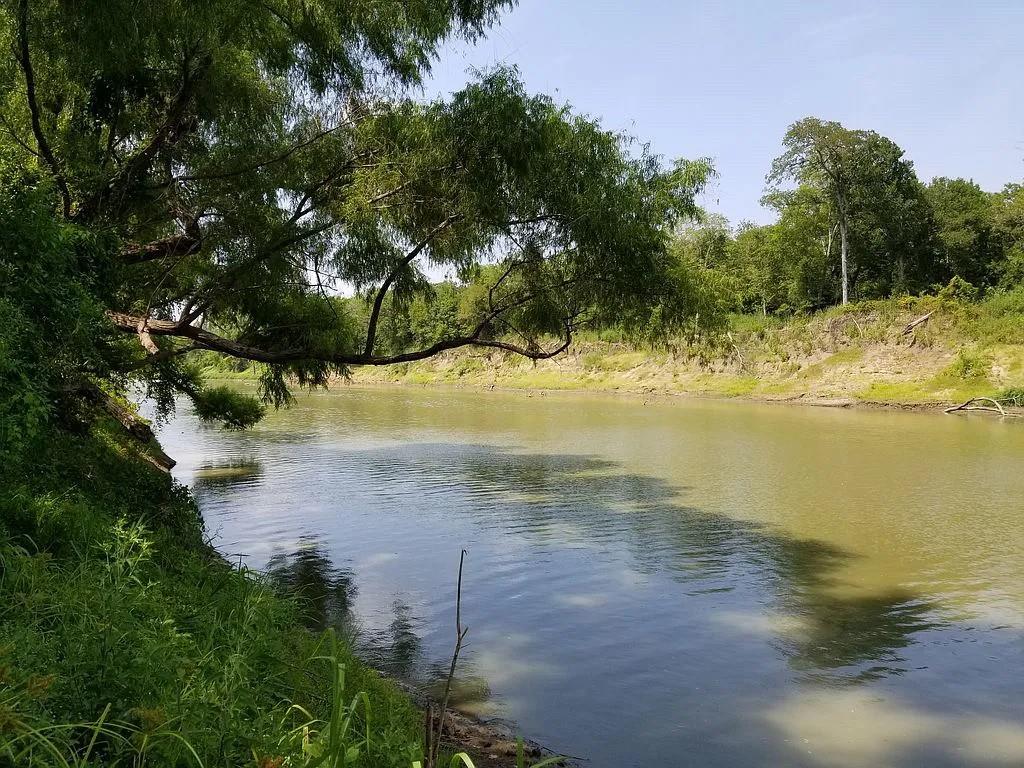 Fantastic 1.28-acre property offering 160 +/- feet of Trinity River frontage! Whether you're an avid hunter or an angler seeking tranquility, this land is a dream come true for outdoor enthusiasts. With direct access to the river, cast your line and reel in a variety of fish species, including world-class gar! The property has an electric pole in place and rural water nearby. You can easily set up your hunting cabin, fishing retreat, or simply create a peaceful oasis to escape the hustle and bustle of everyday life.