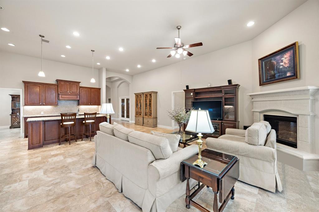 The beautifully designed living area is adorned with sleek tiled floors, high ceilings, and baseboards that add character to the space.