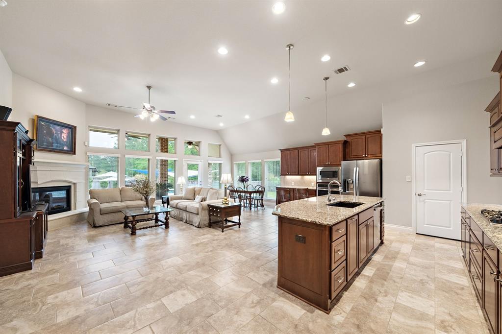 The open-concept living areas offer plenty of floor space for additional cabinetry and seating areas. Revel in plenty of natural light and stunning backyard views, courtesy of the tall windows.