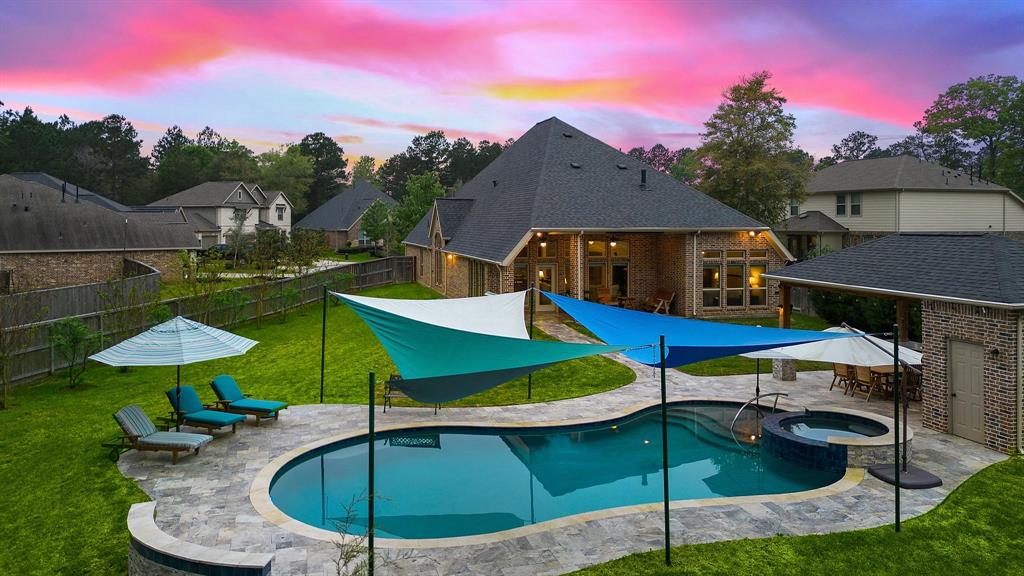 Host memorable gatherings in the fully-fenced backyard, flaunting a covered patio and travertine walkways that lead to the pool, cabana, a great summer kitchen, and the shed for abundant storage space. The property offers a massive outdoor space with space for a garden and open-air activities.