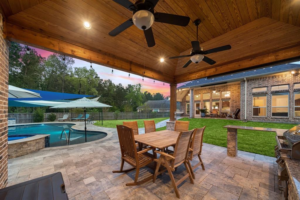 Host BBQ nights in the sprawling, fully-fenced backyard with a brick patio, outdoor seating, and a covered cabana with a summer kitchen and half bath just right beside the pool!