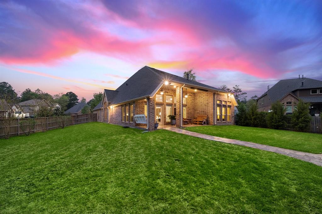 Endless possibilities await in the sprawling backyard, offering manicured landscaping, plenty of shrubs, and ample green space for a garden!