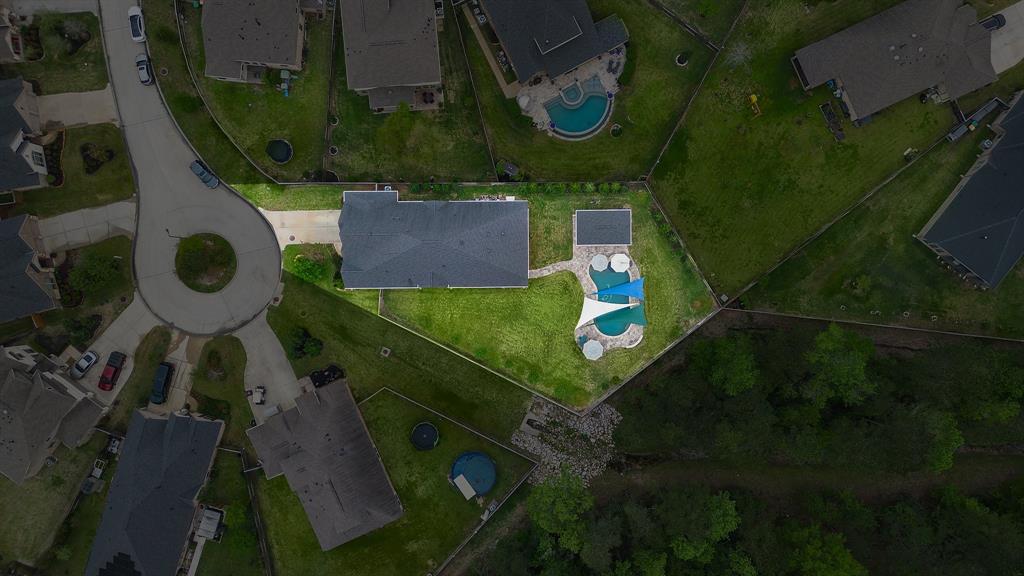 Nestled in a cul-de-sac lot, 335 Fox Trail boasts an oversized, fully-fenced backyard that backs up to a preserve and is complete with a poolside cabana and a summer kitchen.