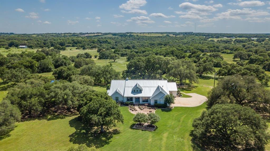 Nestled outside the rolling hills of Burton, Texas lies a remarkable 131-acre ranch blanketed with majestic old-growth live oak trees. This idyllic property presents an enticing opportunity, featuring a newly constructed pond and a thoughtfully renovated 4-bedroom, 3.5-bath house. This ranch offers a harmonious blend of natural serenity and modern comforts, making it a truly desirable escape from the hustle and bustle of city life. The property has two water wells, one large pond, and two smaller ponds, offering plentiful water for wildlife and livestock. The property is currently under a Wildlife Exemption.