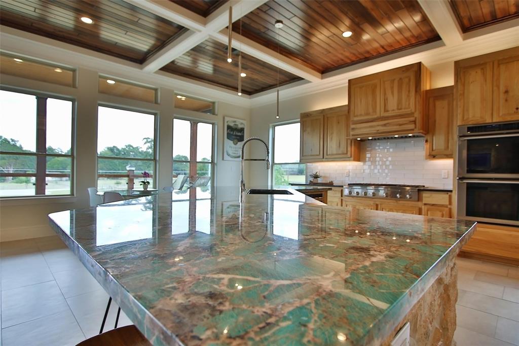 14’ turquoise quartzite island makes a statement in this chef’s kitchen