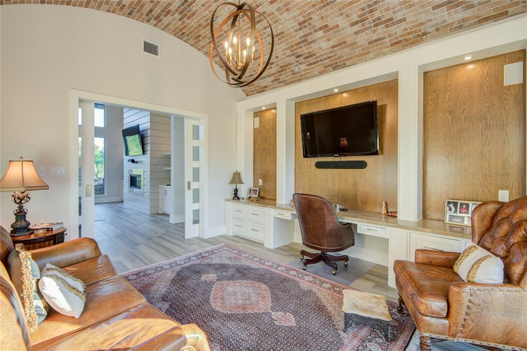 Large office with bricked ceiling and barn doors