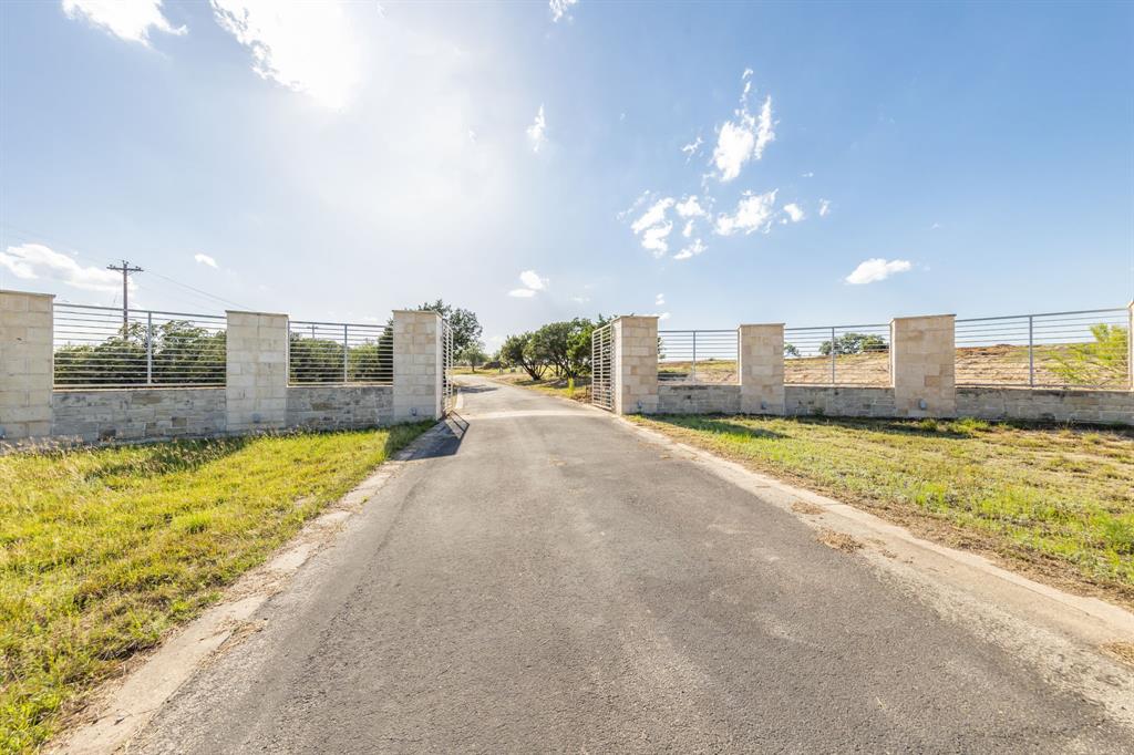 Grand Entrance Gate within the gated subdivision to your private property of 23.85 acres.Garden Beds align both sides of the entrance.    A High Game Fence surrounds the acreage except for the waterfront area.