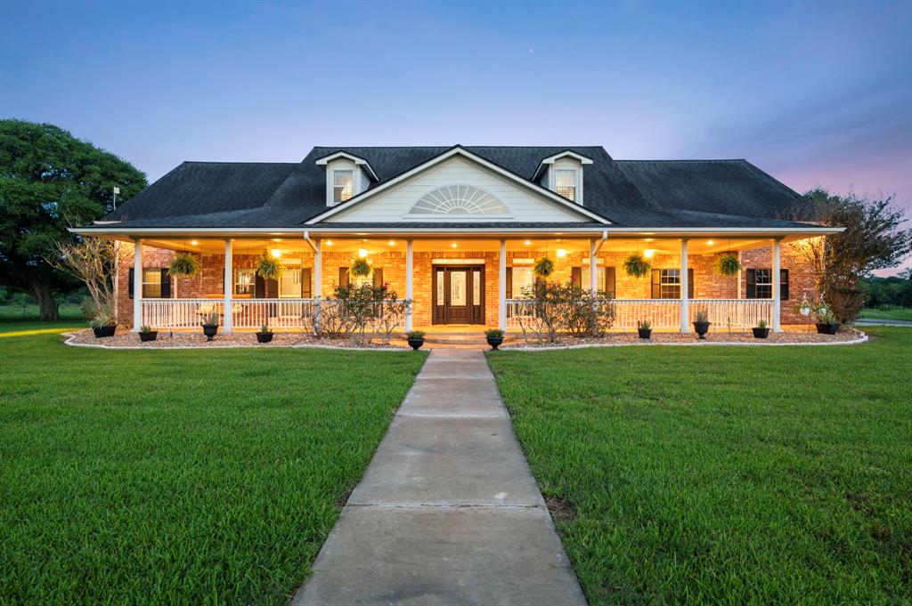 19245 FM 442 Road Boling, Texas The "Ponderosa Ranch" is located in Fort Bend County, Texas & nestled on a sprawling 20+acre spread w/captivating sunset views that paint the sky w/a kaleidoscope of warm hues every evening under a blanket of Texas stars! The ranch features mature TREES, pond, & is the perfect set up for any Equestrian enthusiast. The interior consists of 4299+/-sqft boasting 4 generous sized bedrooms, & an open & airy floor plan making this home both comfortable for daily living & spacious for entertaining. Floor-to-ceiling windows in the living room provide endless views of the acreage & wildlife that frequent the property. Additional features: formal dining, office/study, massive Austin stone fireplace, Wetbar, Kitchen w/island, granite counters, under cabinet lighting, desk nook, & breakfast bar; Gameroom & additional bedrooms located upstairs. Exterior includes: Pool/Spa, Basketball court, Chicken Coop, Horse walker, Barn, Arena w/chute, fenced/crossed fenced pastures! Your dream lifestyle awaits!