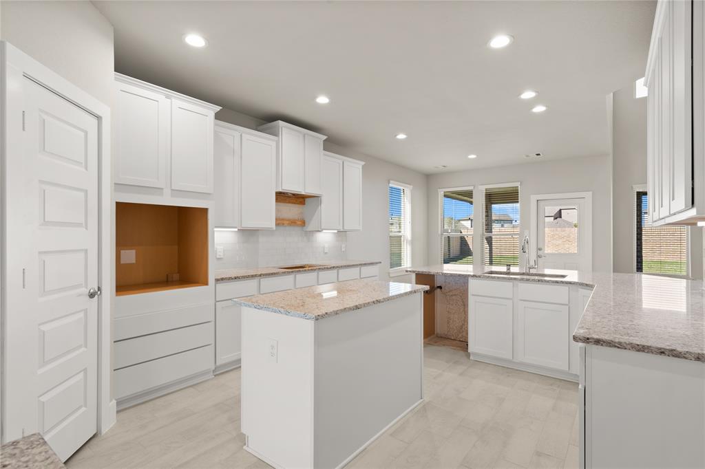 This kitchen will not disappoint! Your family and guests will enjoy many nights of fun, food and entertainment with ample counterspace and kitchen island for setting up a wonderful array of provisions.