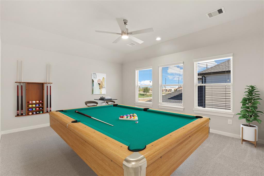 Come upstairs and enjoy a day of leisure in this fabulous game room! This is the perfect hangout spot or adult game room, this space features plush carpet, high vaulted ceiling, recessed lighting, custom paint and large windows with privacy blinds.