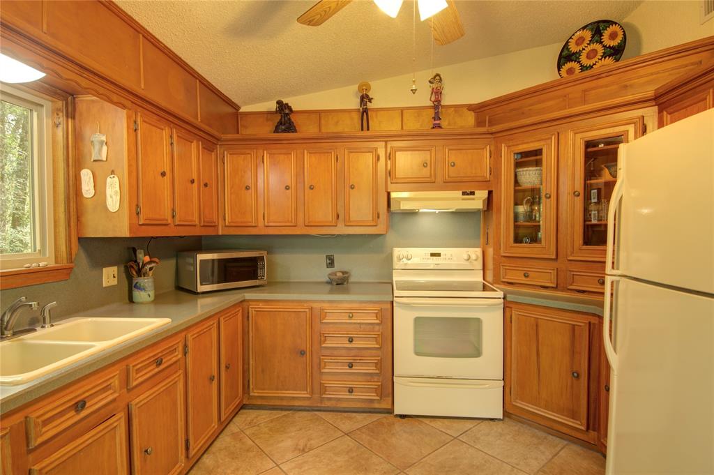 This kitchen has wonderful views of the side and front yards.  Watch the birds while you prepare your meals.